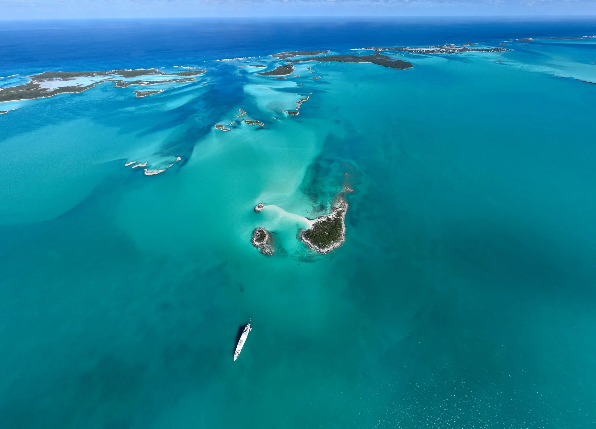The Exuma Cays from the air: sandbanks, a lone superyacht at anchor and water in every blue