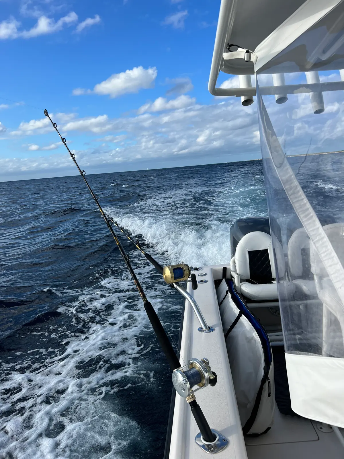 Rods out over the wake on the fishing tender off Nassau