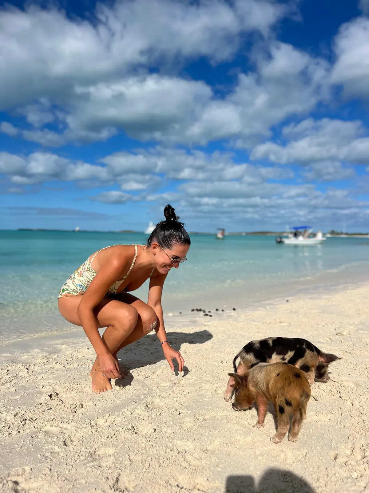 Ellie on the sand with two piglets at Big Major